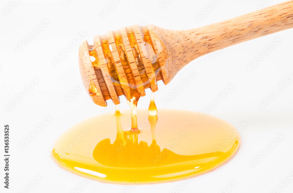 Honey dripping with honey stick. Honey dripping with honey stick.