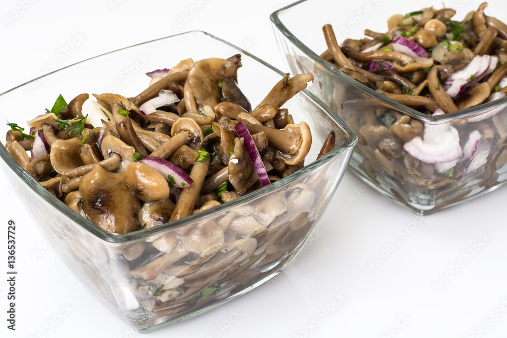 Marinated mushrooms and onions in a glass salad bowl Marinated mushrooms and onions in a glass salad bowl