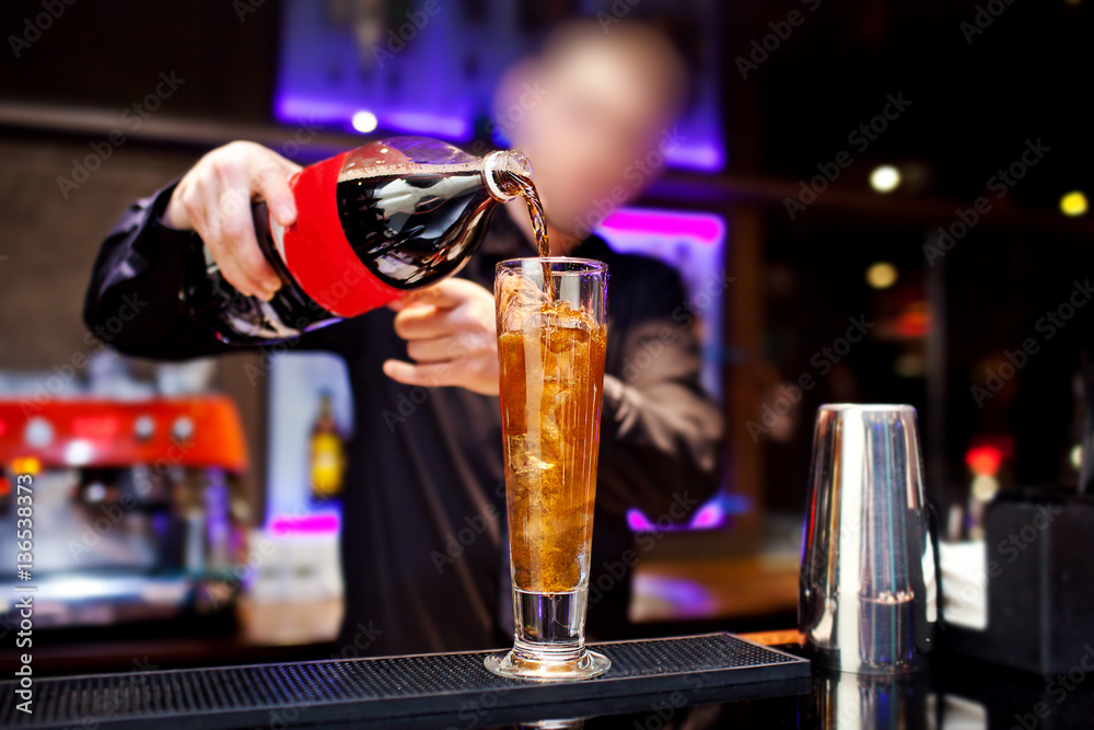 Barman prepares cocktail at the night club
