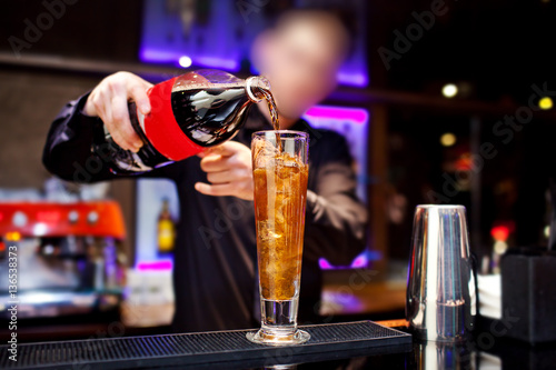 Barman prepares cocktail at the night club