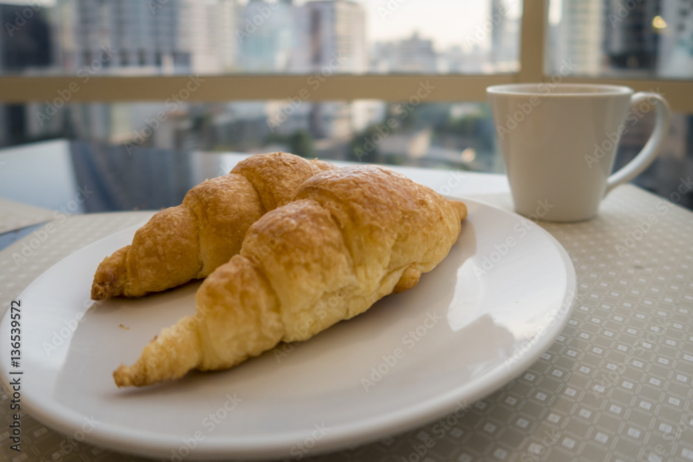 Breakfast with coffee and fresh croissants, selective focus Breakfast with coffee and fresh croissants, selective focus