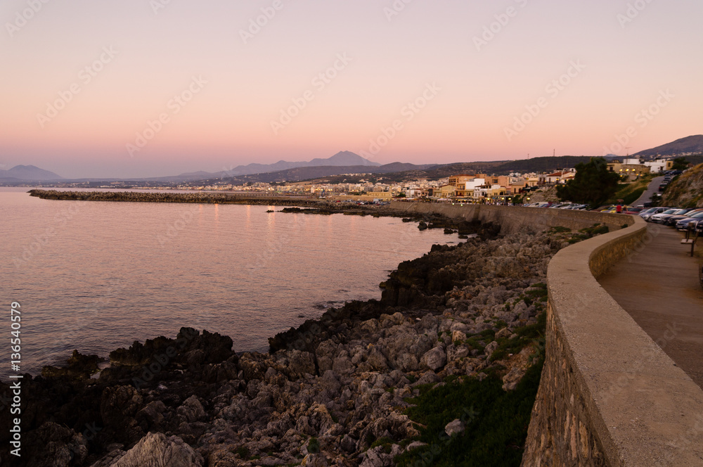 Promenade along the coast and below Fortezza fortress at twilight, city of Rethymno, Crete, Greece