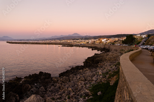 Promenade along the coast and below Fortezza fortress at twilight, city of Rethymno, Crete, Greece