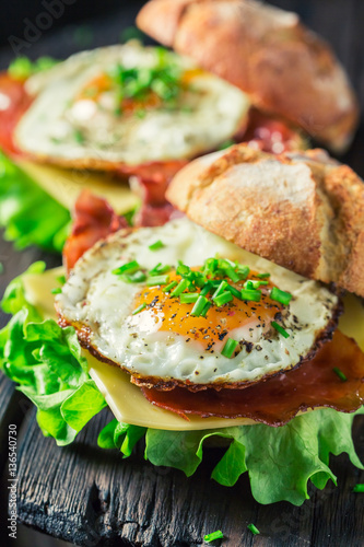 Closeup of homemade burger with bacon, eggs and cheese