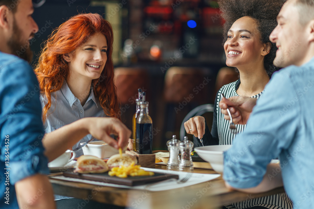 Group of friends talking and having fun at dinner party. Group of friends talking and having fun at dinner party.