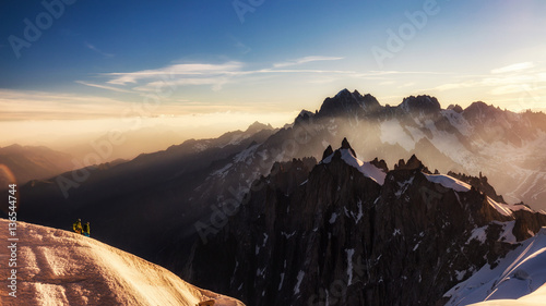 Hikers in high mountains in the morning 