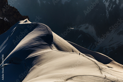 Two hikers on a rigde in high mountains