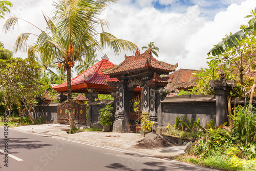 House with figured gate and tiled roof in Ubud, Indonesia. Traditional asian architecture.