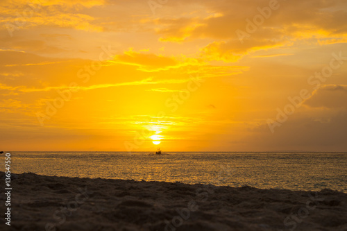 Boat on sunset background