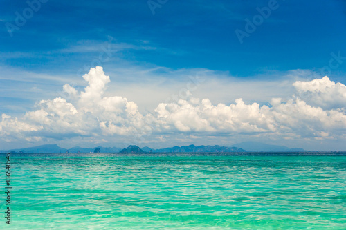 Amazing beautiful tropical turquoise sea under the blue sky with white clouds
