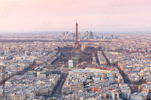 Aerial view of Paris skyline with Eiffel Tower, Les Invalides and business district of Defense at pink sunset, as seen from Montparnasse Tower, Paris, France © Kavalenkava