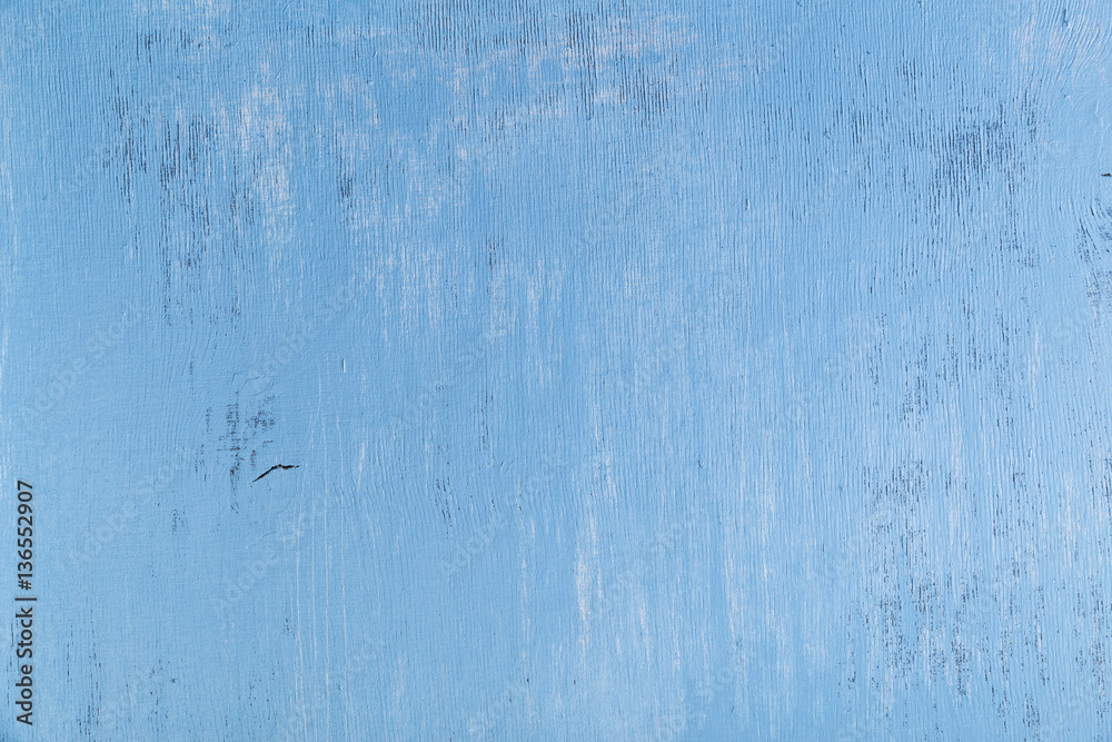 Blue wood background. Painted scraped wooden board. Grunge plywood texture or pattern.