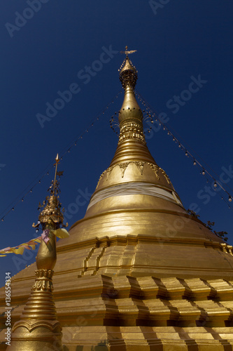 Amazing golden stupa  chedi and pagoda in buddhist temple in Thailand with deep blue sky background