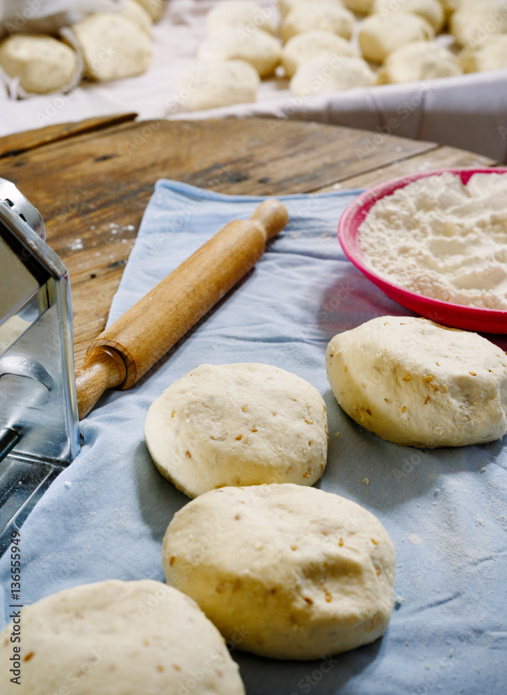 Pita dough with rolling pin.. Pita dough with rolling pin..