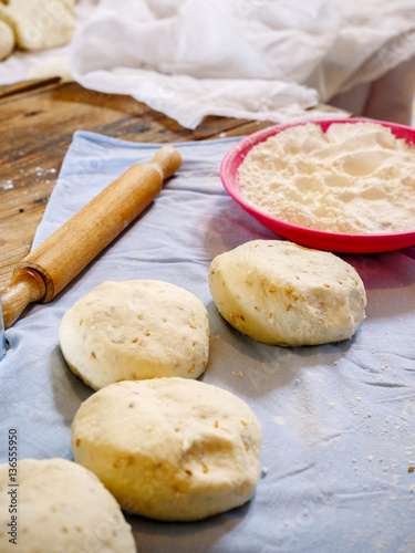 Pita dough with rolling pin..