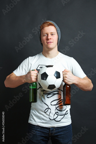 Football fan with beer and ball