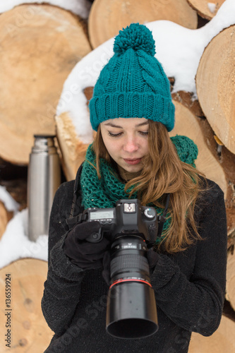 Girl photographs a large camera in winter photo