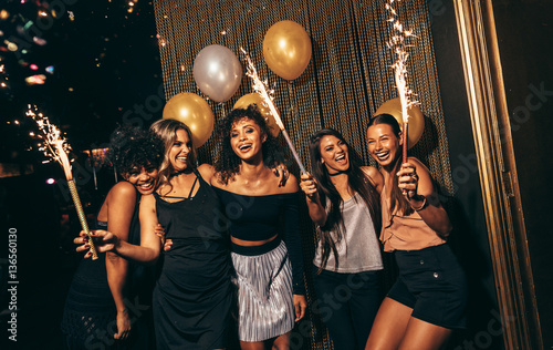 Photography Group of women celebrating with fireworks at pub