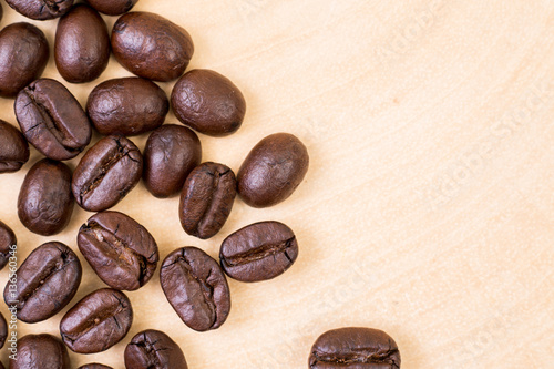 Top view of roasted coffee bean on wood texture background