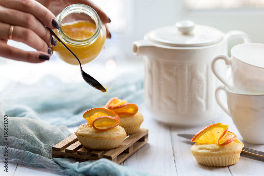 The process of decorating cupcakes with orange jam The process of decorating cupcakes with orange jam