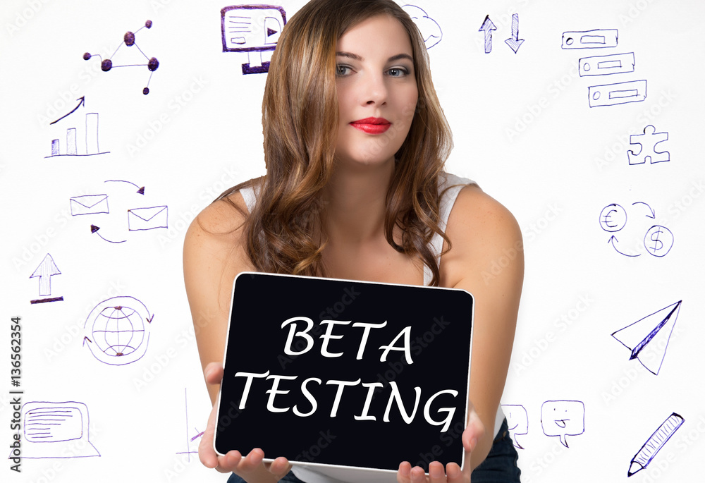 Fototapeta premium Young woman holding pc tablet with writing word: beta testing. Technology, internet, business and marketing concept.