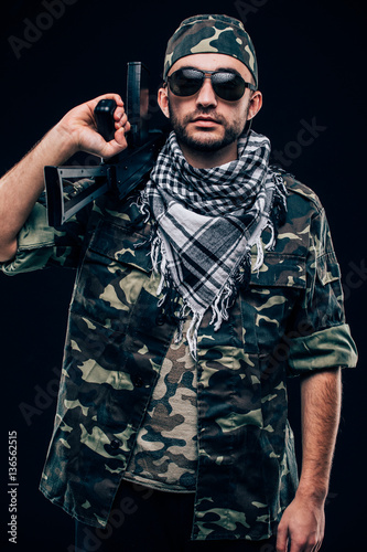 Portrait of armie forces with weapon in hands on black background photo