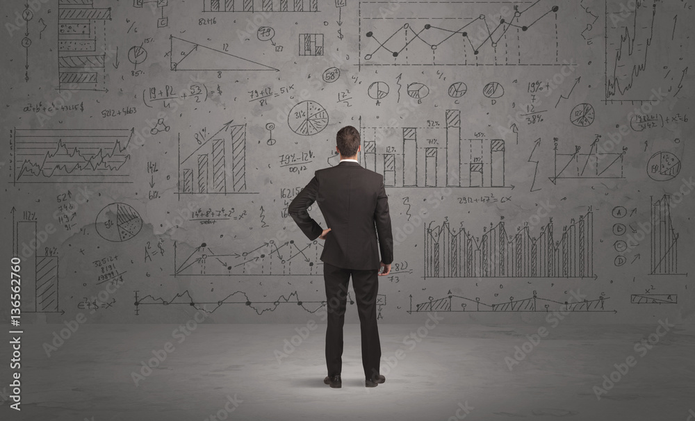 Salesman with business charts on wall Salesman with business charts on wall
