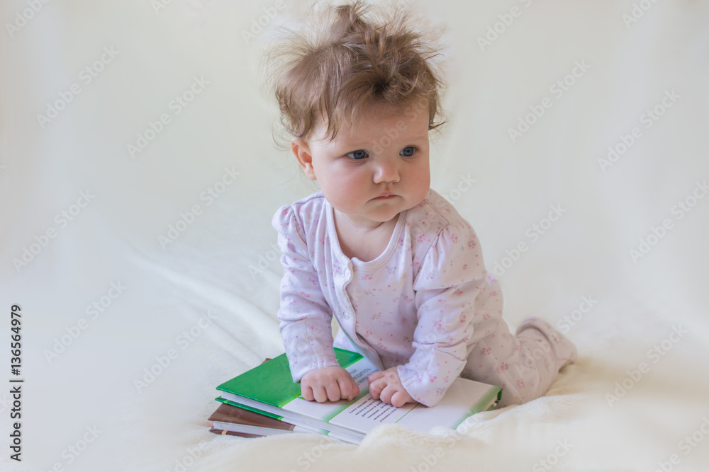A baby with books. A baby with books.