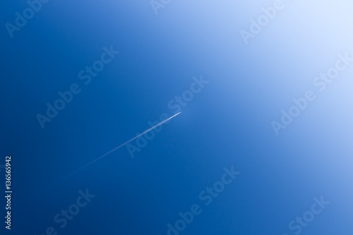 Airplane soars into the blue sky