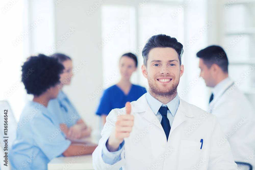 happy doctor over group of medics at hospital