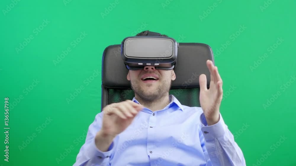 Man in a virtual reality mask observing digital video game world. 4K. Green screen.
Man in a virtual reality mask observing digital video game world. 4K. Green screen.