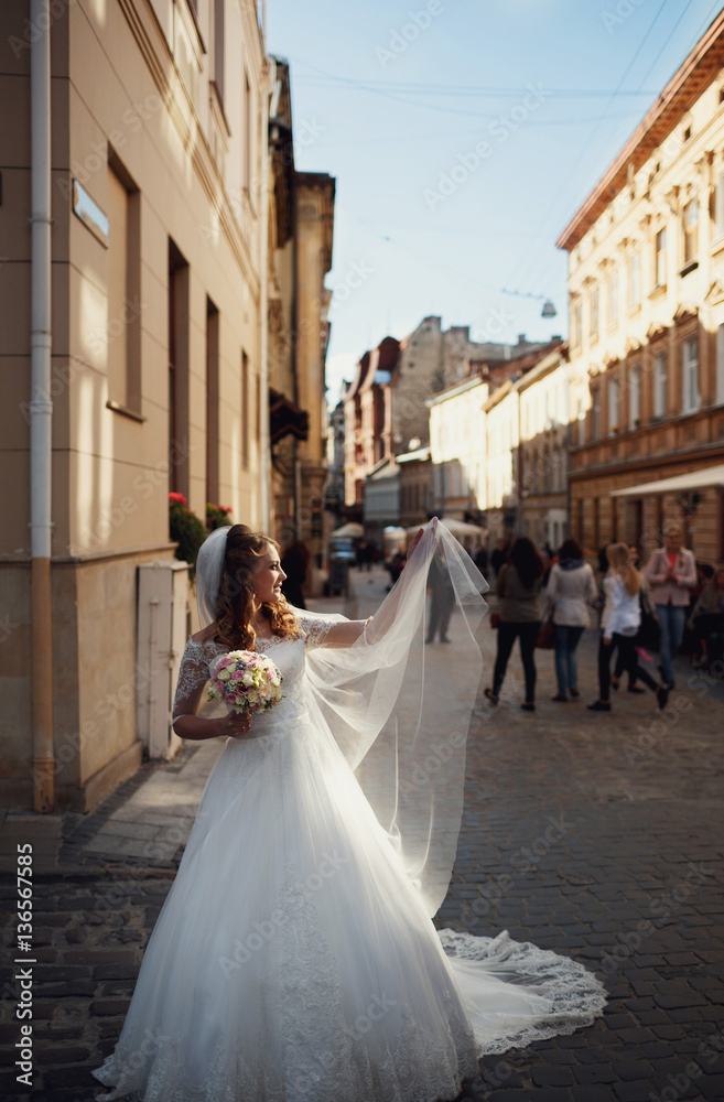 Happy beautiful bride posing in the old city