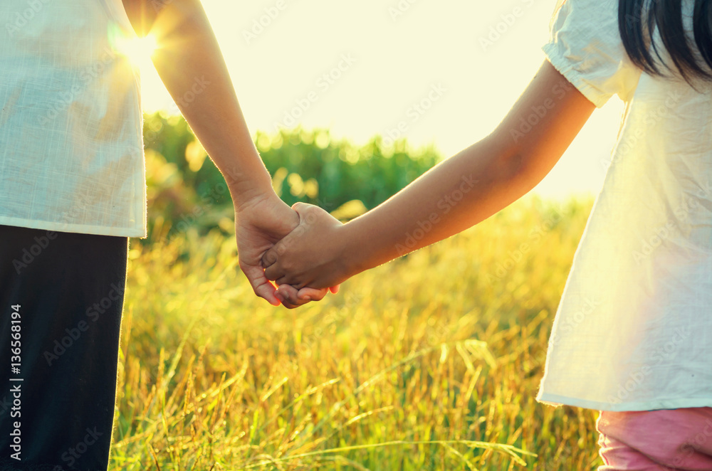 elder sister and younger sister holds the hand and sunset elder sister and younger sister holds the hand and sunset