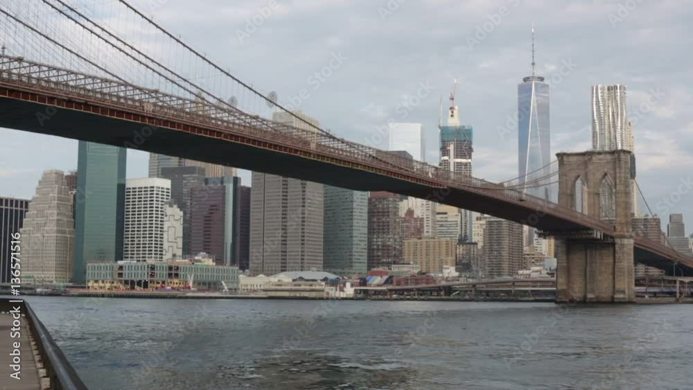 Brooklyn Bridge and New York city skyline pan, cloudy sky Brooklyn Bridge and New York city skyline pan, cloudy sky