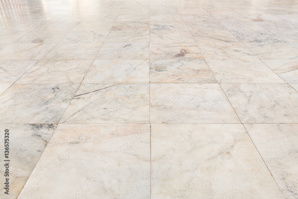 Real marble floor tile in perspective with beige abstract texture pattern of natural material i.e. stone, rock. Smooth surface for decorative wall, floor of interior building i.e. bathroom, kitchen.