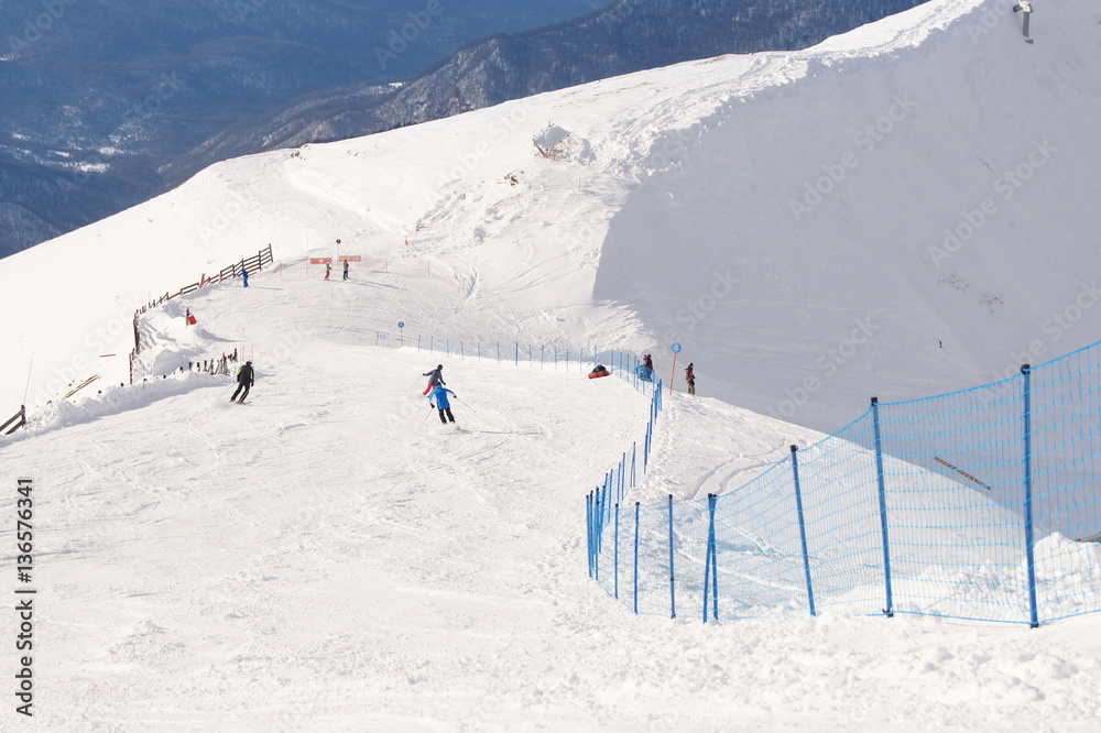 People skiing descend.