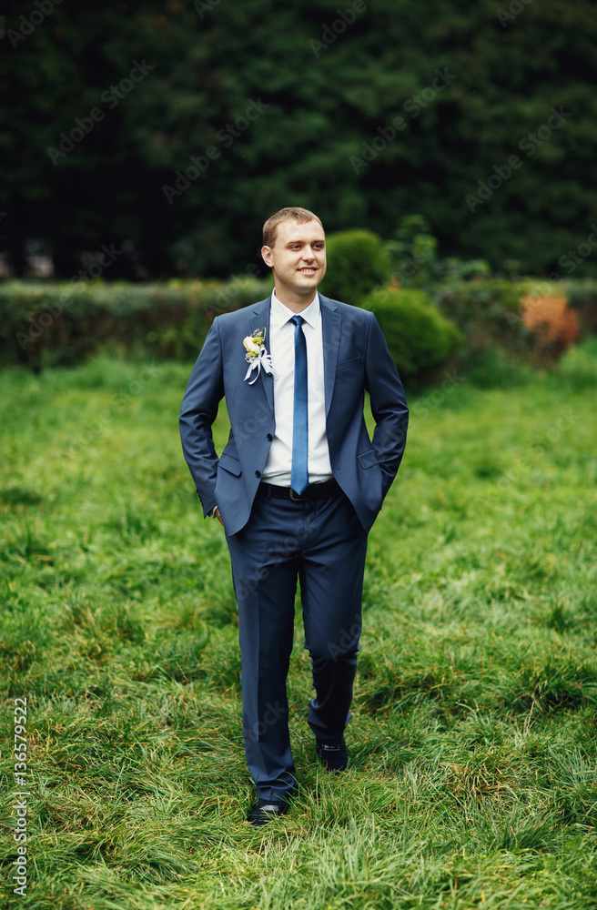 a wonderful young man standing among the green meadow a wonderful young man standing among the green meadow