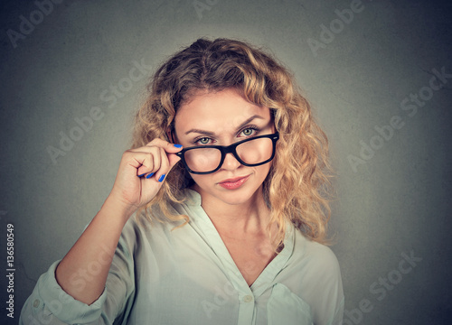 confused skeptical woman looking at you with disapproval photo