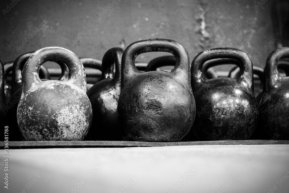 Obraz premium Old worn dumbells in gym in black and white