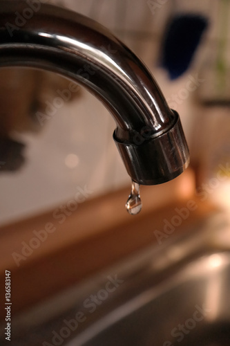 Water drop falling from a tap