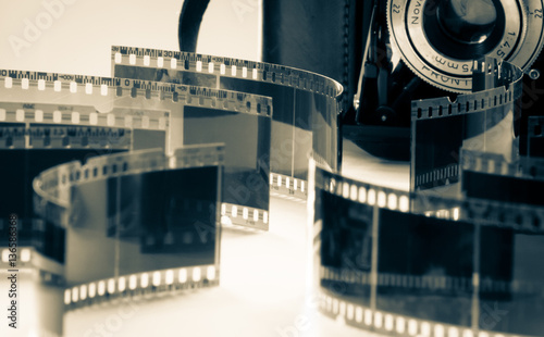 black and white photo of an old analogue camera displayed with negatives  photo