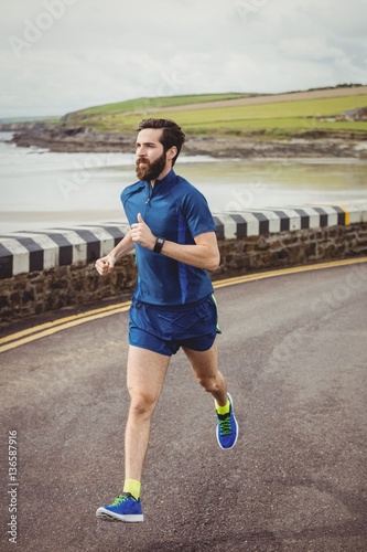 Athlete running on the road photo