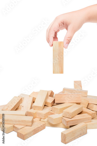 Hand playing with the wood game (jenga). isolate on white backgr