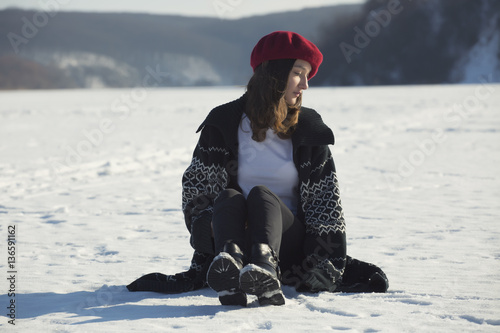 Girl with red beret on the winter landskapes photo