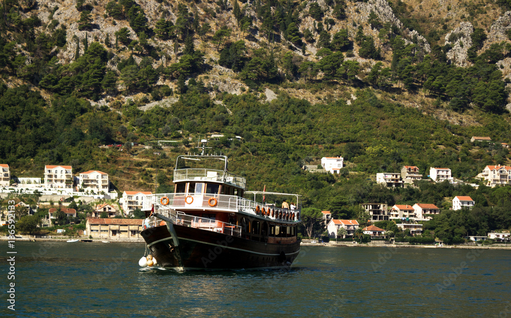 Wooden ship in the Adriatic sea with mountains in the background Wooden ship in the Adriatic sea with mountains in the background