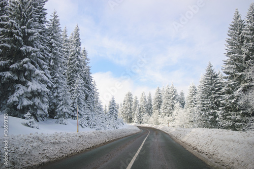 Clean winter road on mountain with turns and curve with trees un