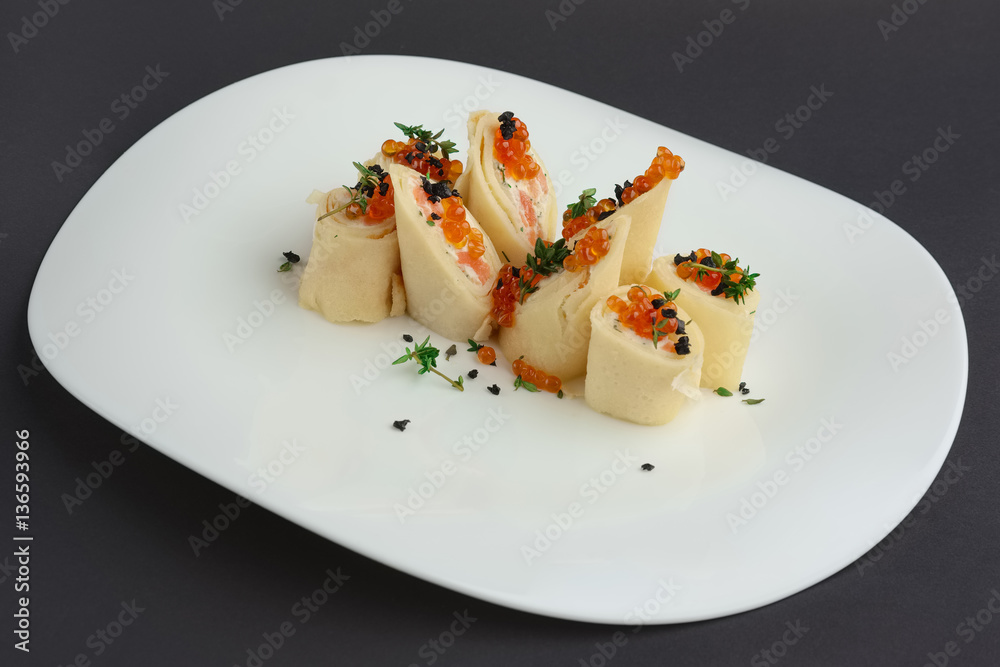 pancakes with salmon and caviar on big white plate pancakes with salmon and caviar on big white plate