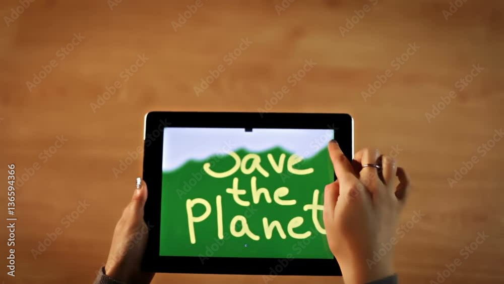 Top view female hands erasing Save the planet bold, calligraphy on digital tablet, planet eco destruction symbol hd Top view female hands erasing Save the planet bold, calligraphy on digital tablet, planet eco destruction symbol hd