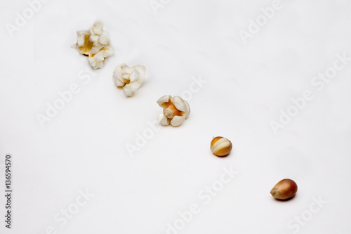 stages of preparation of popcorn on a white background