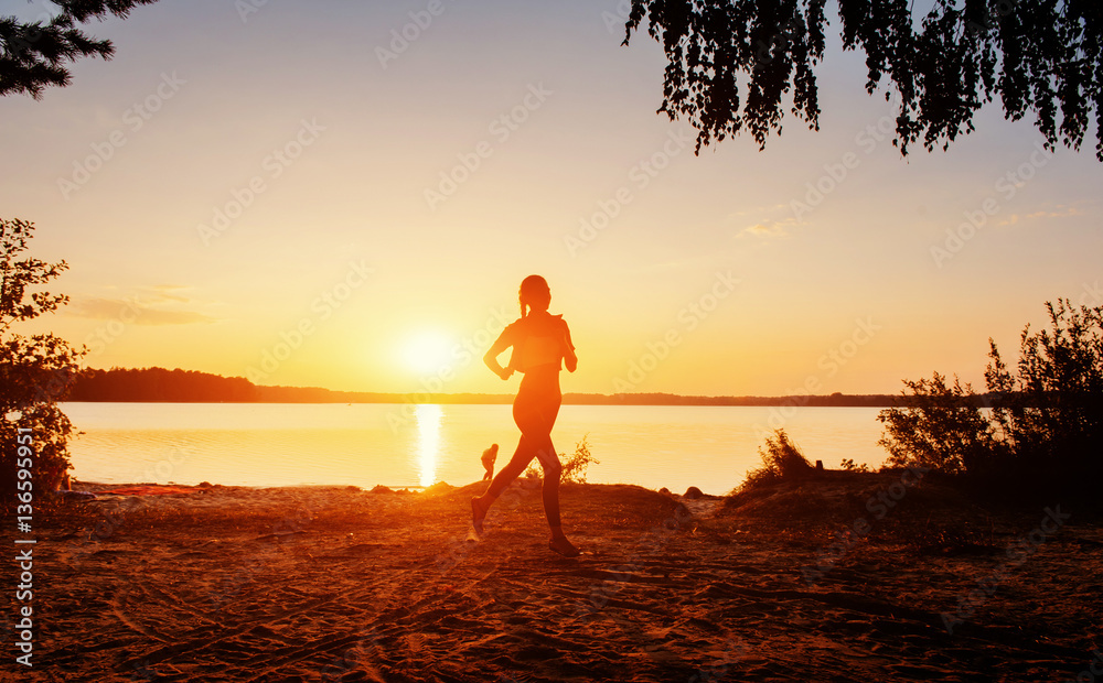 Fototapeta premium girl at sunset by the lake